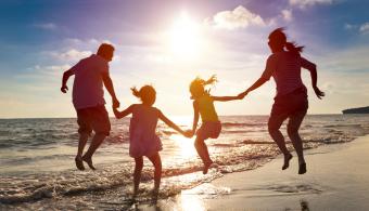 A family on the beach during the sunset